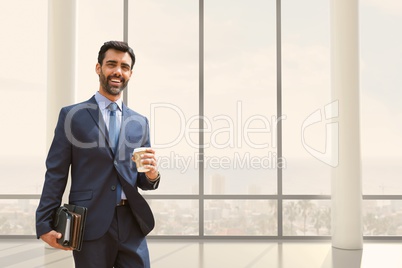 Happy business man standing against building background