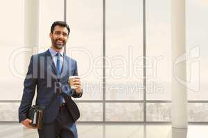 Happy business man standing against building background