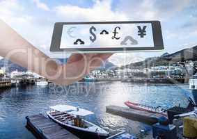 Holding tablet and currency upload online over marina