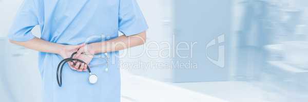 Doctor holding a stethoscope against blue background