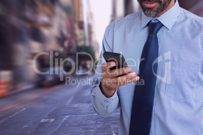 Business man looking at a phone against city background