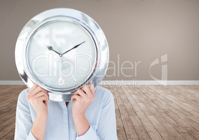 Woman holding clock in front of room