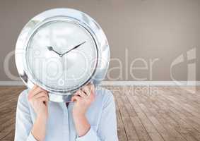 Woman holding clock in front of room