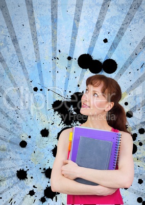 Young student woman holding notebooks against blue splattered background