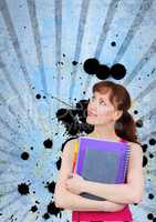 Young student woman holding notebooks against blue splattered background