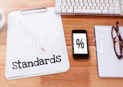 Standards percentage text written on page with phone