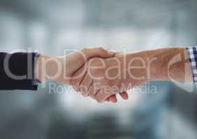 Business people shaking hands against blurred background
