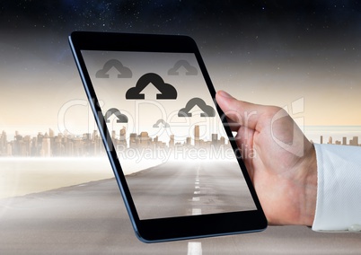 Holding tablet and Cloud icons over city
