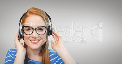 Happy business woman listening to music against grey background
