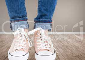 Feet and shoes on wooden floor