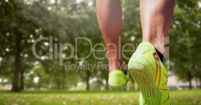 Athletic feet running in park