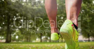Athletic feet running in park