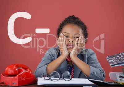 Sad office kid girl at a table against red background with C- text
