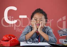 Sad office kid girl at a table against red background with C- text