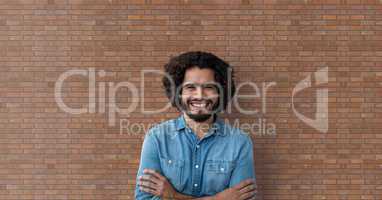 Happy business man standing against brick wall background