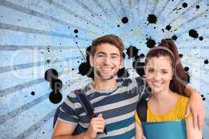 Happy young students standing against blue splattered background