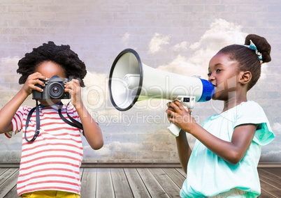 kids holding megaphone and camera with cloudy room background