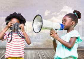 kids holding megaphone and camera with cloudy room background