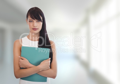 Business woman holding a folder against white blurred background