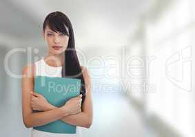 Business woman holding a folder against white blurred background