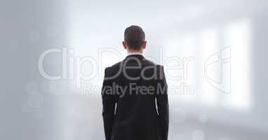 Business man standing against white blurred background