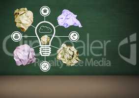 light bulb with crumpled paper balls in front of blackboard