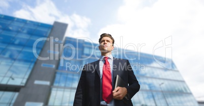 Business man standing against building background