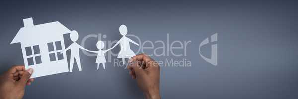 Hands holding paper figures against blue background as house and family insurance concept
