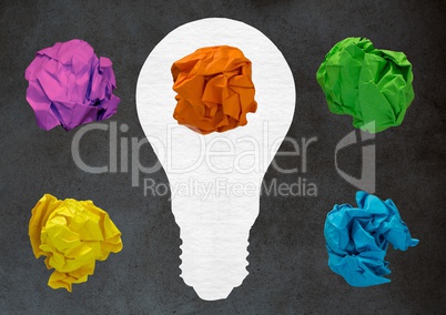 light bulb with crumpled paper ball in front of blackboard