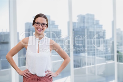 Happy business woman standing against city background