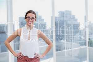 Happy business woman standing against city background