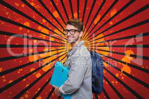 Happy young student man holding a folder against red, black and orange splattered background