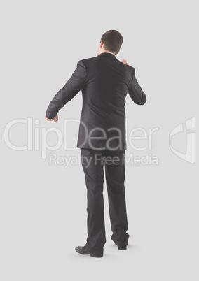 Full body portrait of man standing with grey background