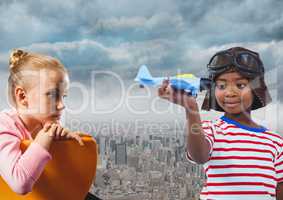 Kids with toy plane over city
