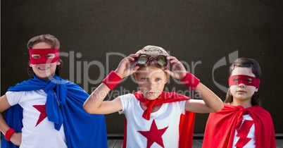 Superhero kids in front of blackboard