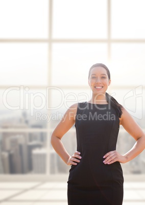 Happy business woman standing against building background