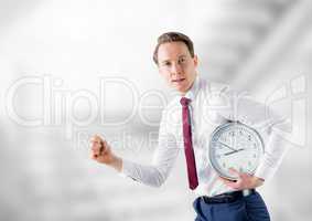 man holding clock in front of stairs