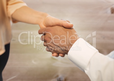Business people shaking hands against wood floor background
