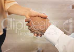 Business people shaking hands against wood floor background