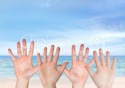 Four hands open in front of the sea