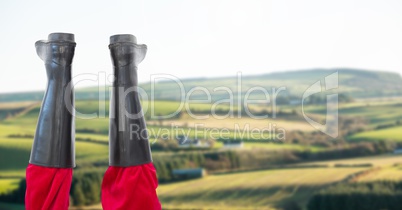 Wellington boots wellies upside down in front of farm landscape nature countryside