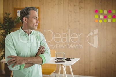 Business man standing against office background