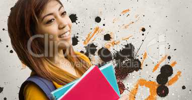 Happy young student woman holding notebooks against grey, yellow and black splattered background