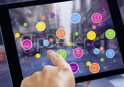 Holding tablet and City with colorful icons