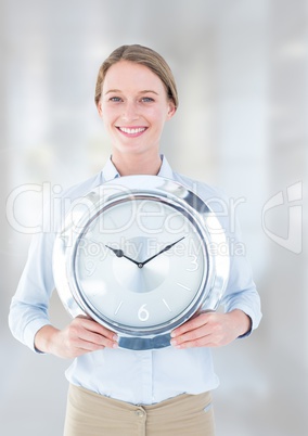 Woman holding clock in front of bright background