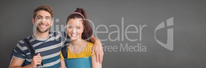 Man and woman standing against wide blank grey