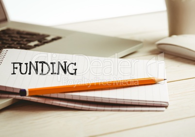 Funding text  text written on page with laptop