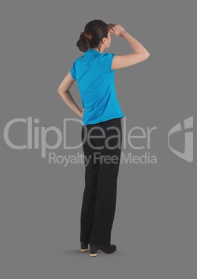 Full body portrait of woman standing with grey background