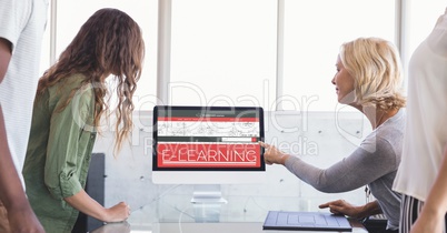 People looking at a computer with E-Learning information in the screen