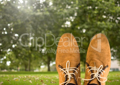 Shoes relaxing feet in front of trees